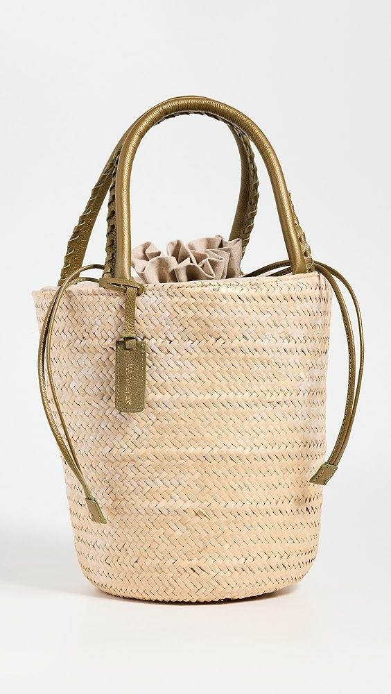 a straw bag with braid handles on a white background