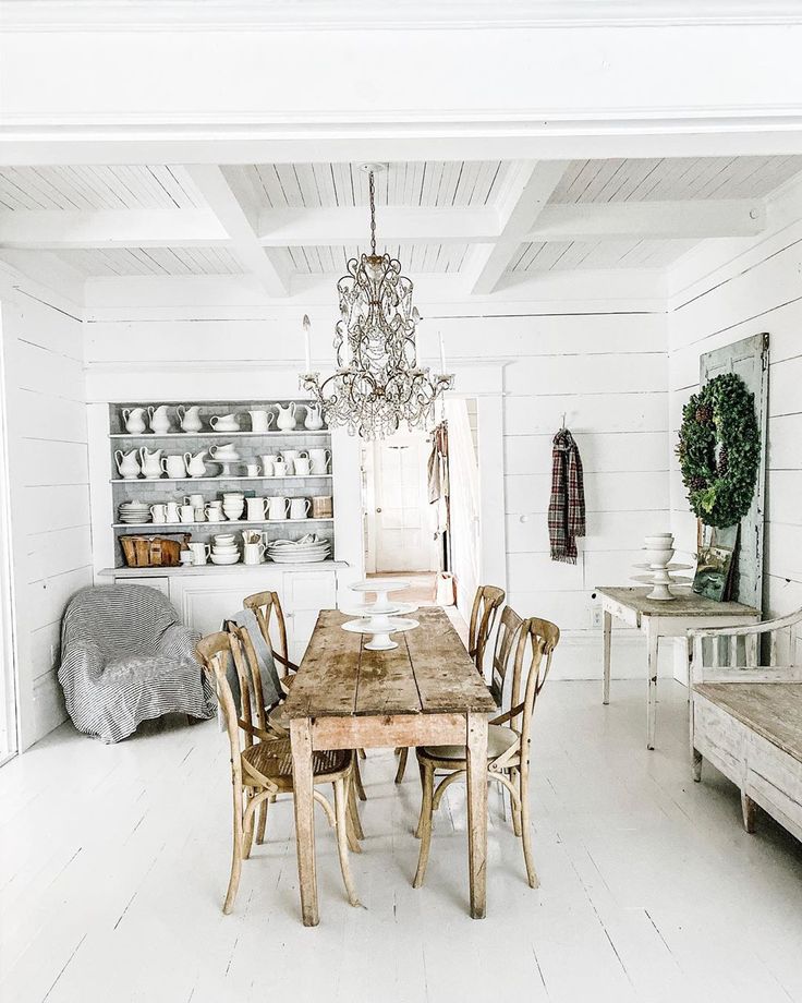 a dining room table with chairs and a bench