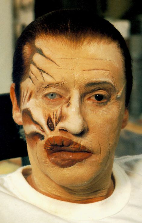 a man with his face painted like a clown