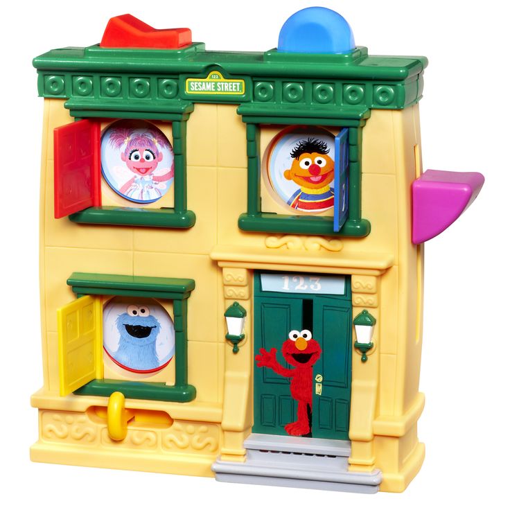 the sesame street building has two characters on it's front and one is in the doorway