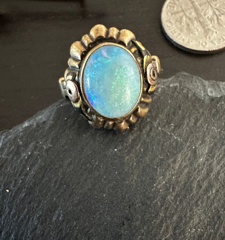 "10K multi gold early 1900s Ring with a colorful natural cabochon Australian Opal(approx 10 by 8mm).  Condition is very good any slight wear commensurate with age-photos show the details.  Size 5, wt.- 2.6 grams, 5/8\" north to south on finger.  Interesting rose gold roses and yellow gold basic setting-A treasure." Oval Blue Opal Ring In 14k Gold, Handmade 14k Gold Oval Cabochon Jewelry, Oval Bohemian Collectible Jewelry, Unique Oval Opal Ring For Jewelry Making, Heirloom Oval Cabochon Opal Ring, Bohemian Oval Cabochon Ring, Vintage Oval Hallmarked Opal Ring, Antique Oval Opal Gemstone Ring, Vintage Hallmarked Oval Opal Ring