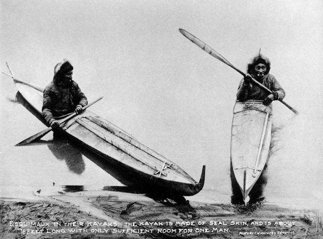 two people in canoes with paddles on their backs, one standing and the other sitting