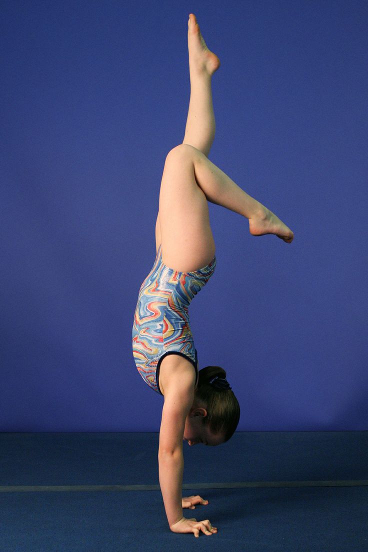 a young child doing a handstand on the floor