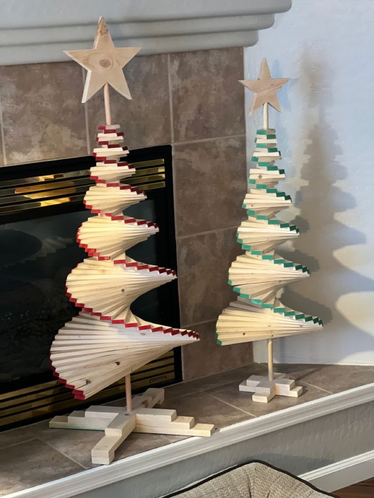 a christmas tree made out of book pages sitting on top of a fireplace mantel