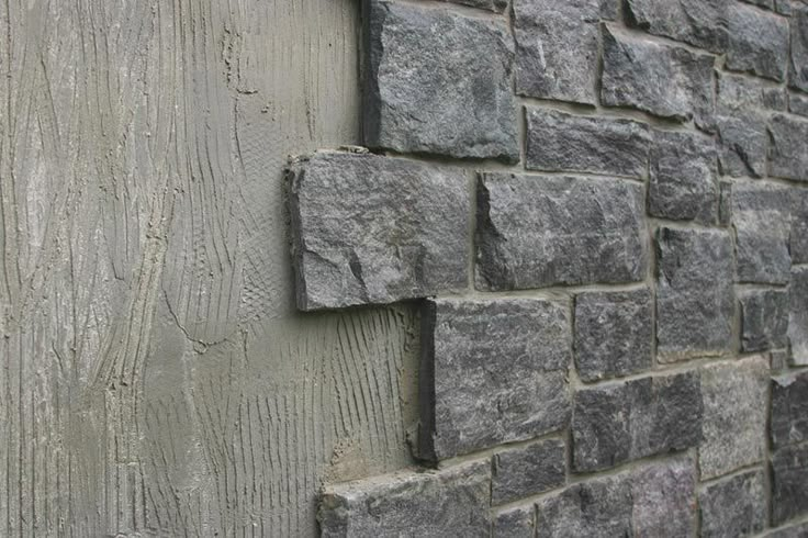 the corner of a building made out of stone