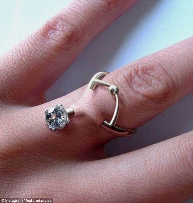 a woman's hand with a ring on it and a diamond in the middle