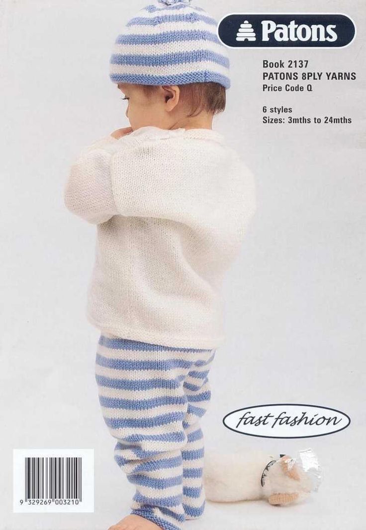 a baby wearing a blue and white striped outfit with a knitted hat on it's head