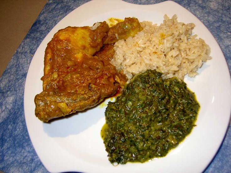 a white plate topped with meat, rice and spinach