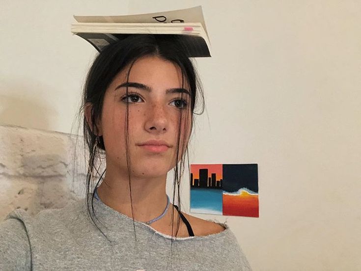 a young woman with her hair in the shape of a book on top of her head