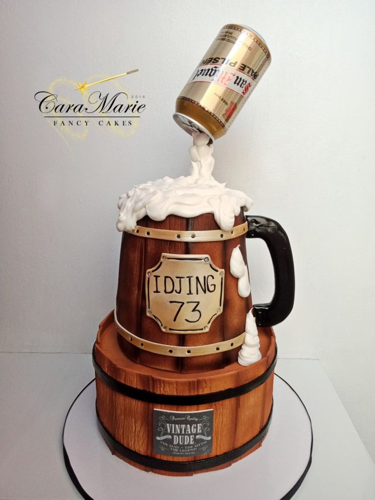 a cake made to look like a wooden barrel with ice cream on top and a beer mug in the middle