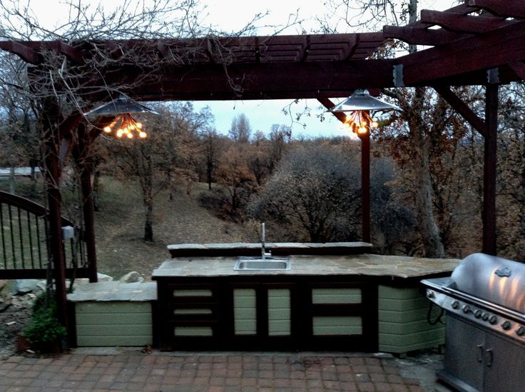 an outdoor bbq and grill area with lights