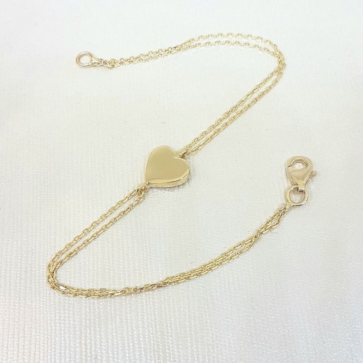 -The heart bracelet is made with high quality 14K real solid gold. The size of the heart is 8mm X 8mm. There is double chain. - This tiny, dainty, charm, delicate and trendy bracelet has been artfully designed for timeless yet modern millennial fashion. - You receive the bracelet in a beautiful and free gift box. - The bracelet length is 7 inches. We can shorten it. just write on personelized ares. - Free shipping (Arrive within 4 business days to USA and Canada ( 1 day for production + 3 days f Adjustable 14k Yellow Gold Heart Bracelet, Classic Heart-shaped Chain Bracelet As Gift, Classic Gold Bracelets For Valentine's Day, Classic Heart Chain Bracelet For Valentine's Day, Classic Heart-shaped Chain Bracelet For Valentine's Day, Classic Heart Shaped Chain Bracelet As Gift, Classic Heart-shaped Chain Bracelet Gift, Classic Heart Bracelet For Valentine's Day Gift, Classic Heart Pendant Bracelet As Gift