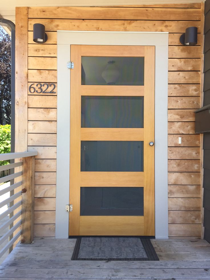 a wooden door on the side of a house