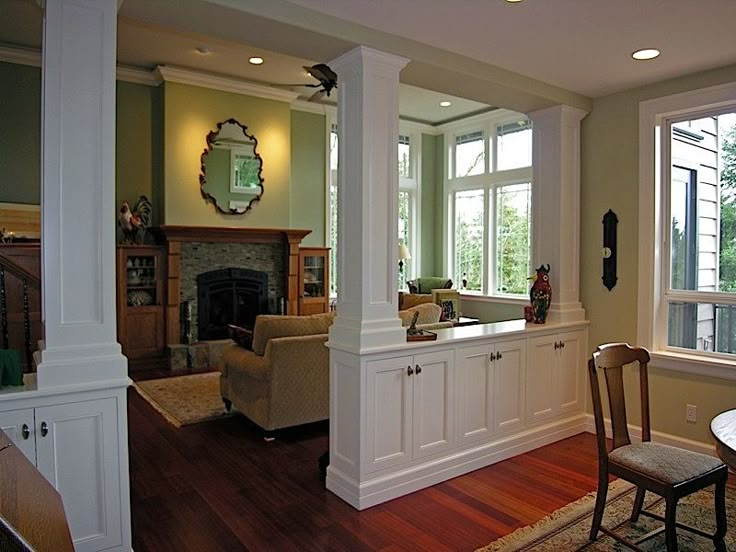 a living room filled with furniture and a fire place next to a kitchen counter top