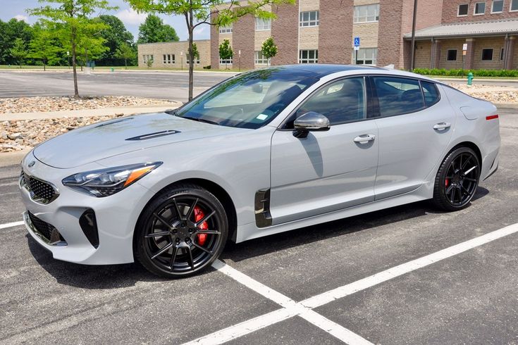 a white sports car parked in a parking lot