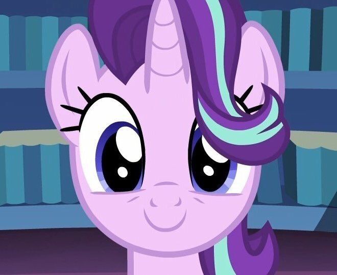 the pinkie pony is standing in front of bookshelves and looking at the camera