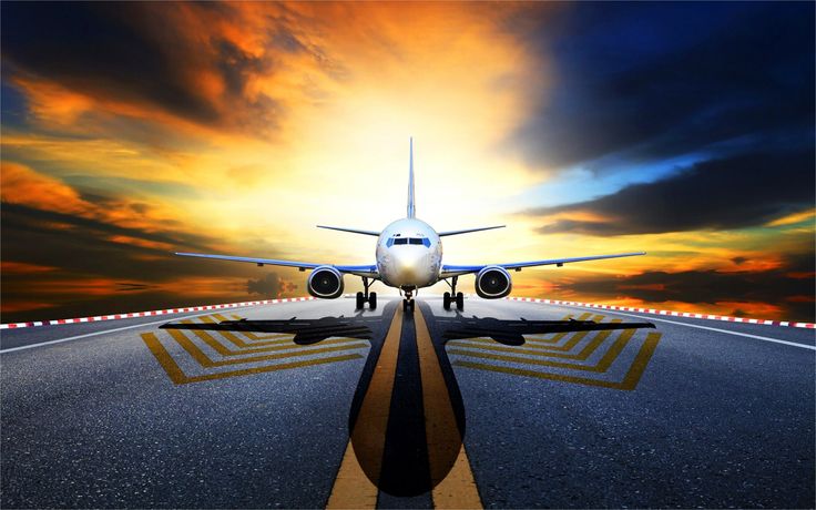 an airplane is taking off from the runway at sunset with clouds in the sky behind it