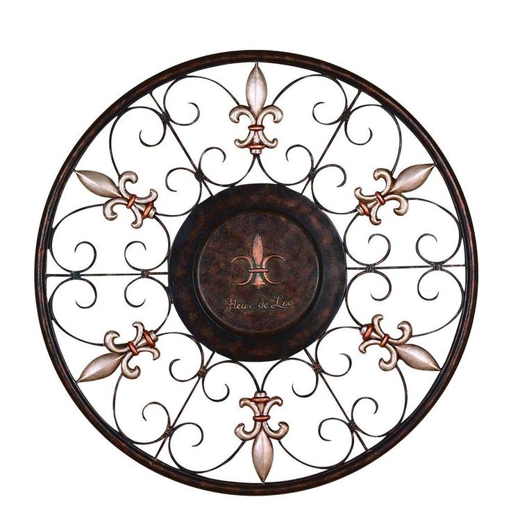 a decorative metal wall clock with fleur de lis on it's face