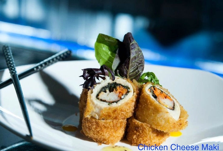 two pieces of sushi on a white plate