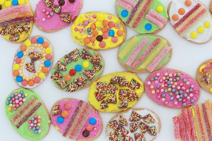 many decorated cookies are arranged on a white surface