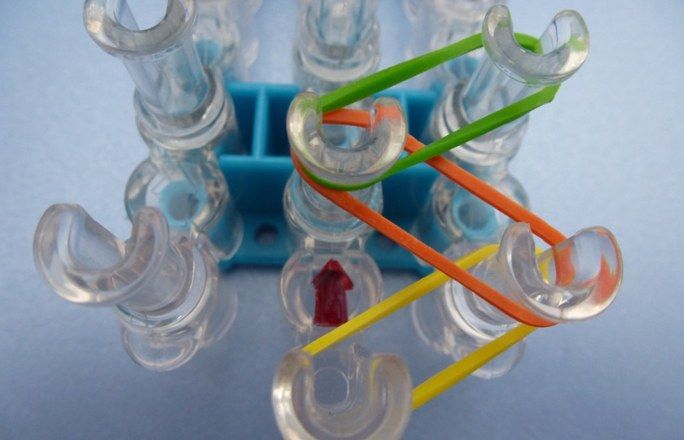 an assortment of different colored toothbrushes sitting on top of each other in front of a blue holder