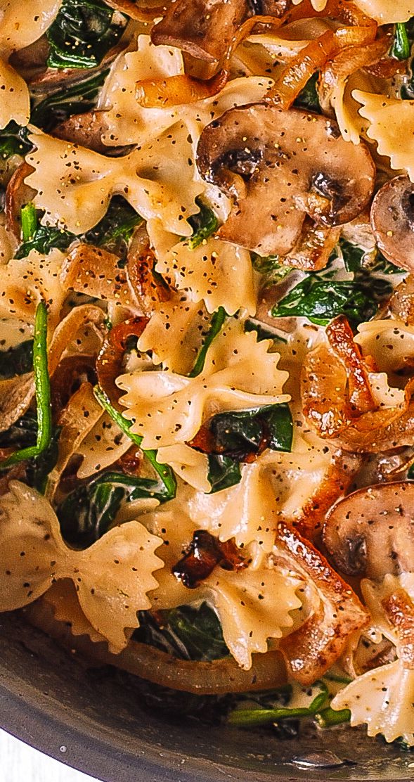 pasta with spinach and mushrooms in a pan