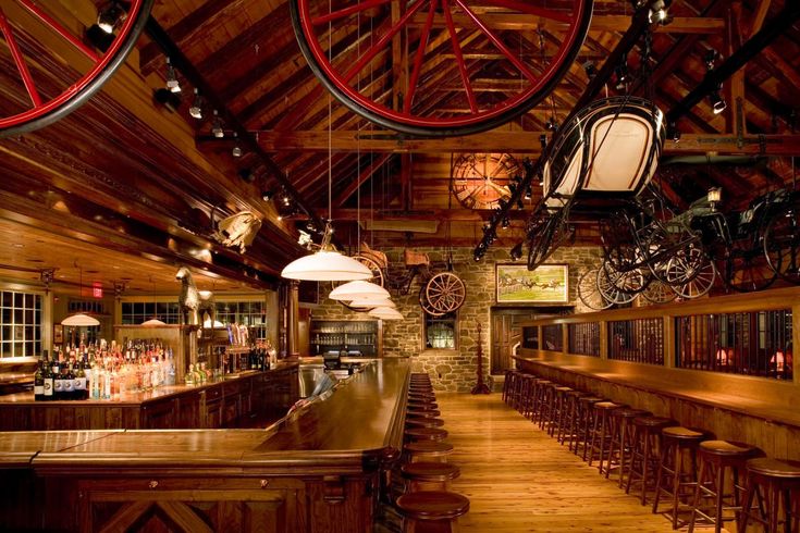 an old fashioned bar with lots of bikes hanging from the ceiling