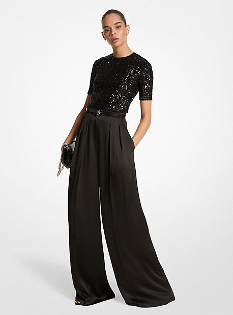 A masterclass in everyday sophistication, these palazzo pants are finely tailored in Italy from liquid-like satin and dyed in a versatile noir hue. The mid-rise silhouette features finely pressed creases that lend effortless movement with each step. Further accentuate the dramatic wide-leg cut with soaring high-heel sandals. Glamorous Luxury Pants For Date Night, Wide Leg Pants Dressy Outfit, Palazzo Pants Outfit Formal, Upscale Fashionable Attire Club Women, Palazzo Pants Cocktail Outfit, Cocktail Outfit Pants Women, Wide Leg Pants Outfit Party, Cocktail Attire For Women Pants, Satin Palazzo Pants Outfit