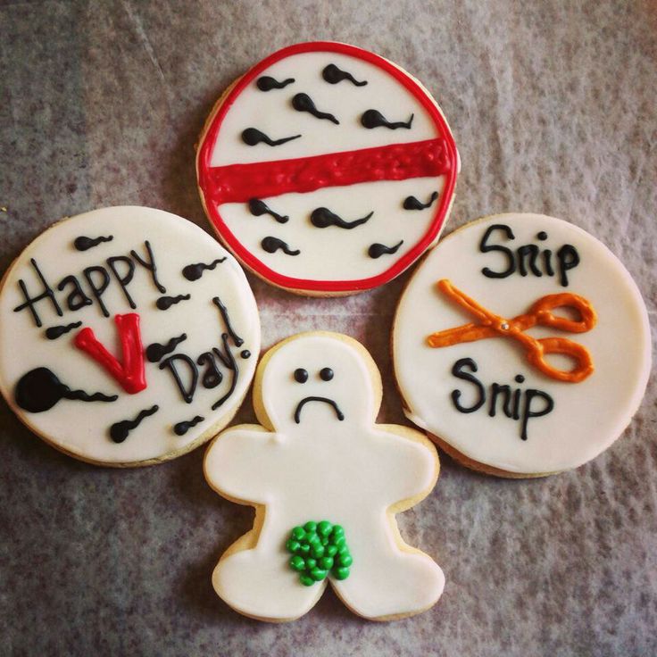 three decorated cookies sitting on top of a table