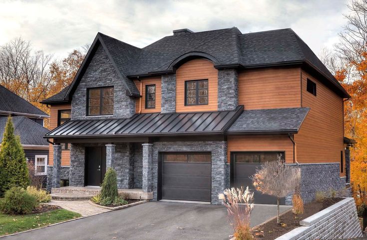 a large house with two garages in front of it