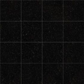 a black tiled wall with white squares on it