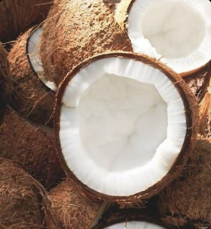 several coconuts with one cut in half and the other whole