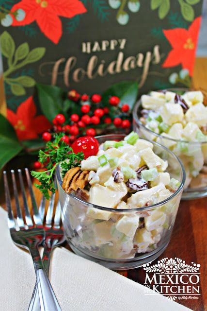 two glass bowls filled with food on top of a wooden table next to a christmas card