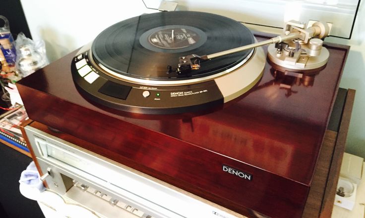 a record player sitting on top of a wooden table