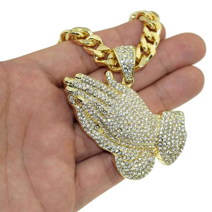 Men's super chunky micro pave Praying Hands pendant on a heavy Cuban Link hip hop chain. High quality gold finish over alloy metal. Chain necklace has very nice weight at 190 grams, lobster claw clasp, 30" inch long and 10 mm wide, for a substantial jewelry piece. Large praying hands shape pendant is encrusted with lots of dazzling stones and is 70MM tall by 44MM Wide wide and 6mm thick. Enjoy 100% FREE SHIPPING in the USA Metal Chain Necklace, Hip Hop Chains, Praying Hands, Super Chunky, Hand Shapes, Cuban Link Chain, Pendant Gold, Cuban Chain, Cuban Link