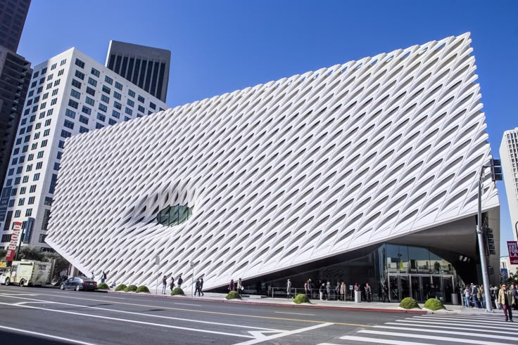 a large white building on the corner of a city street