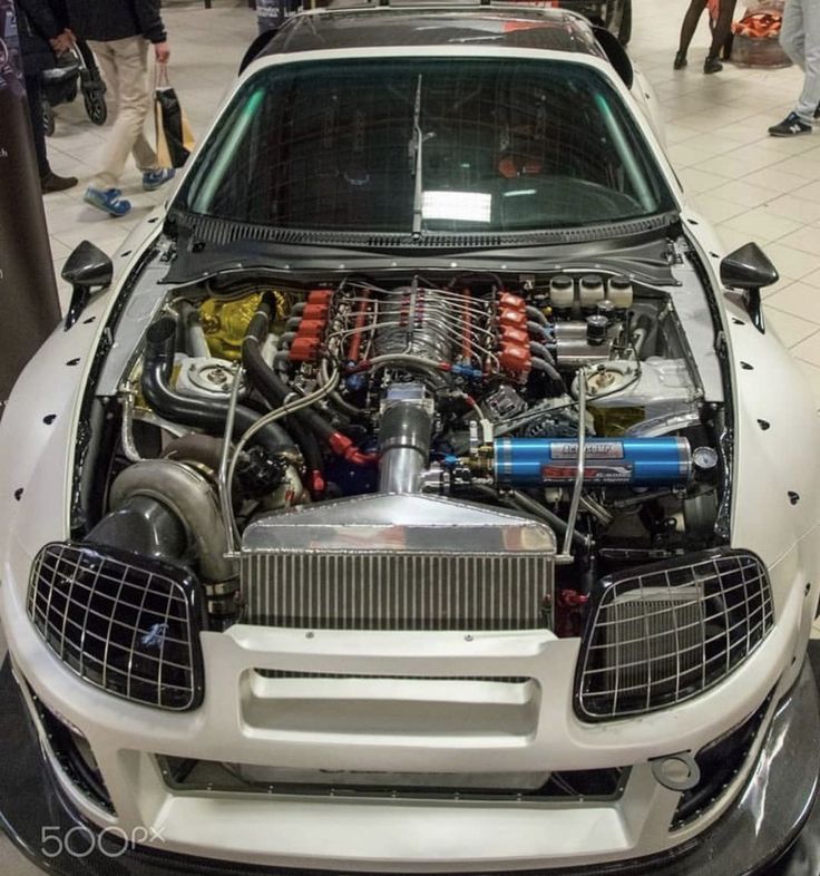 the engine compartment of a car on display in a showroom