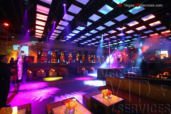 the interior of a nightclub with purple lighting