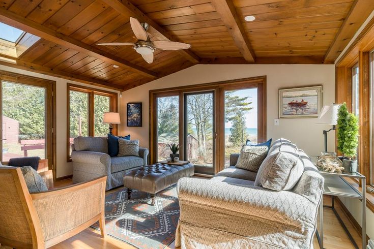 a living room filled with furniture and lots of windows