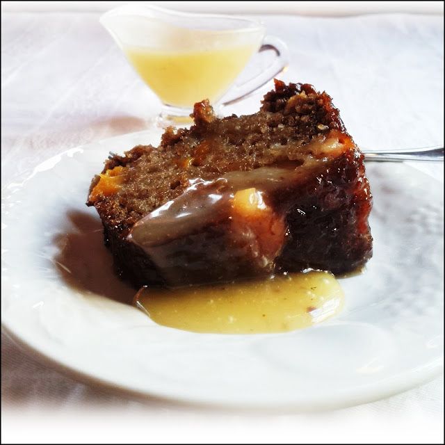 a piece of cake sitting on top of a white plate next to a small cup