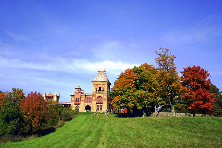 an old building on top of a grassy hill