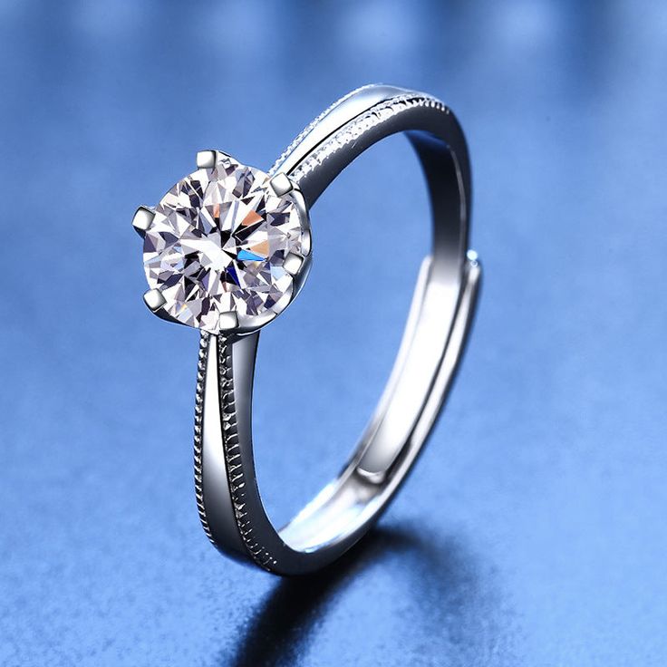 This S925 Silver Moissanite Proposal Ring offers a classic look. Crafted with Sterling Silver and natural moissanite, this ring is truly a timeless piece of jewelry. A high-quality/durable piece you can cherish forever. Product Details: Material: 925 Sterling Silver Stone: Moissanite Diamonds/D /1 carat Weight: about 2.33g Size: Adjustable Open Size Diamond Size: 6.5mm SKU: AN23102620 Keywords: moissanite rings, moissanite engagement rings, moissanite ring, moissanite diamond ring, moissanite en خواتم خطوبة, Blood Diamond, Moissanite Diamond Rings, Creating Jewelry, Proposal Ring, Blue Zircon, Moissanite Ring, Moissanite Rings, Diamond Sizes