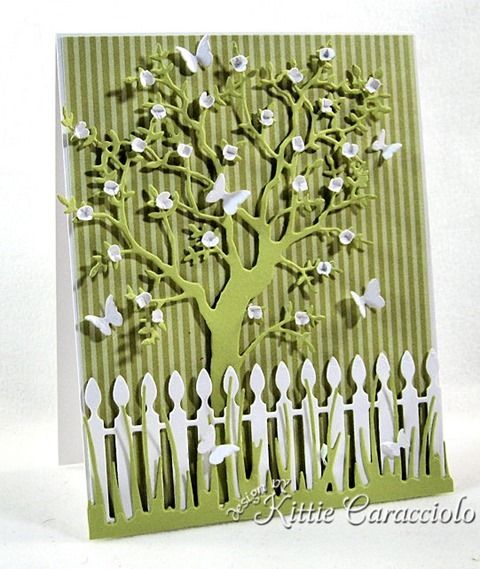 a card with a tree and fence on it