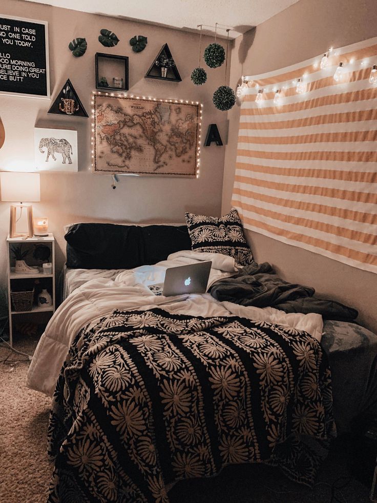 a bed room with a laptop computer on top of it