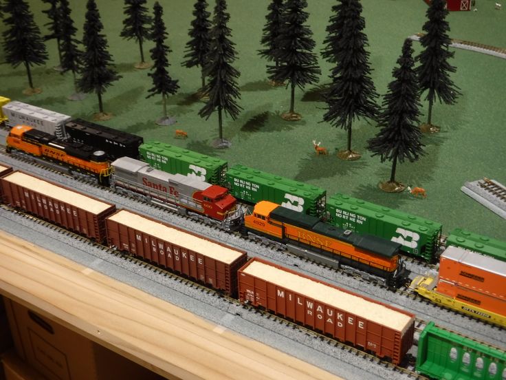 a model train set with trees and trains on the tracks