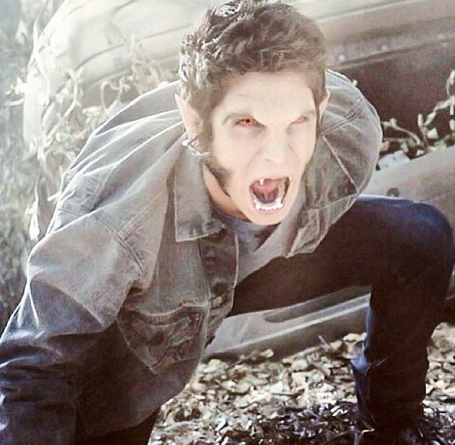 a man with his mouth open standing in front of a car