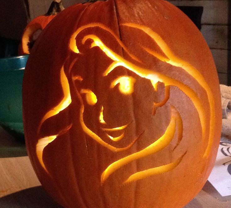 a carved pumpkin with the face of a woman on it