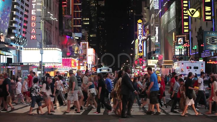 many people are crossing the street at night in times square, new york city ny