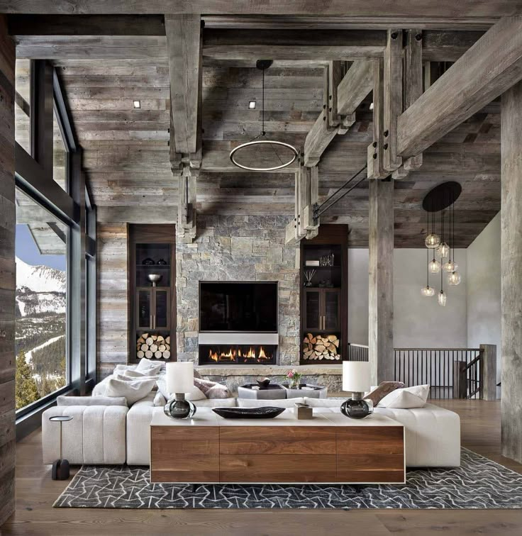 a large living room with wooden ceilings and white couches