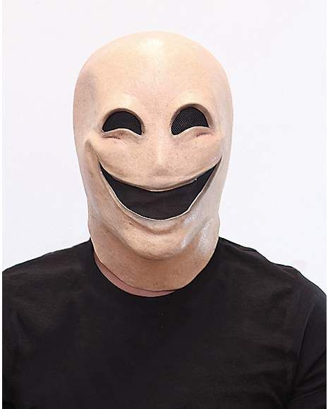 a man wearing a white mask with a smile on it's face and black t - shirt